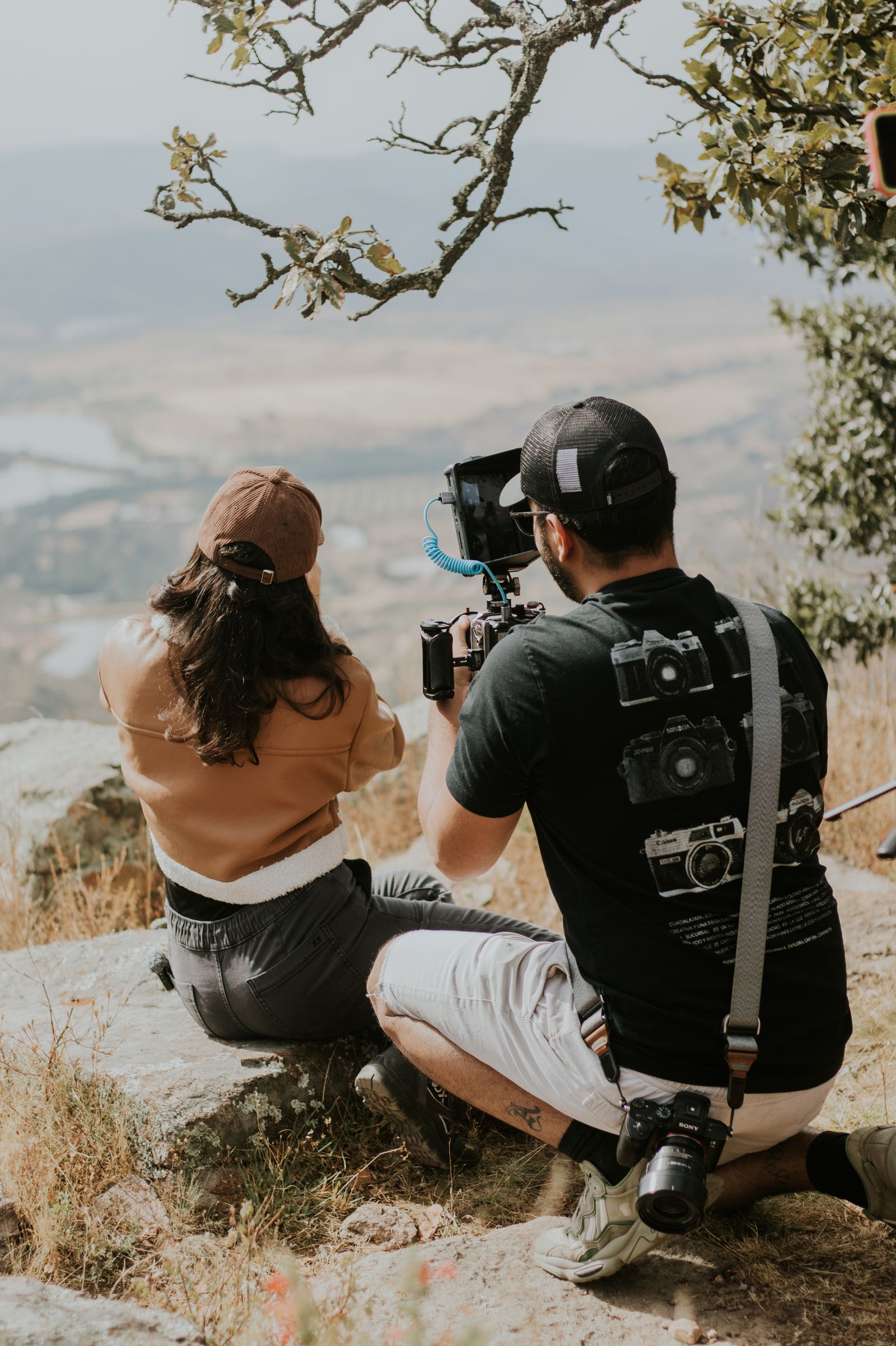 Two filmmakers framing a landscape shot together